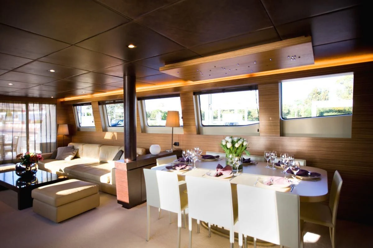 a room with tables and chairs aboard GIOE I Yacht for Sale