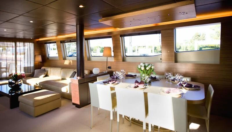 a room with a table and chairs aboard GIOE I Yacht for Sale