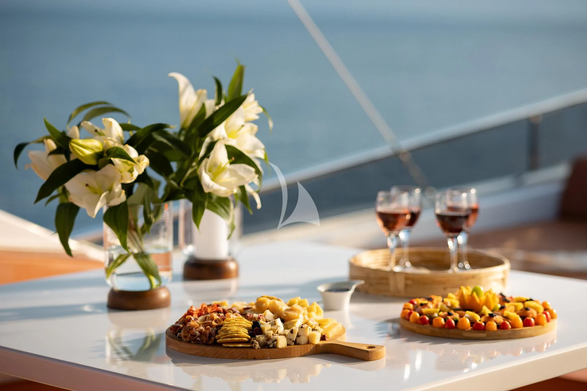a table with food and glasses aboard GIOE I Yacht for Sale