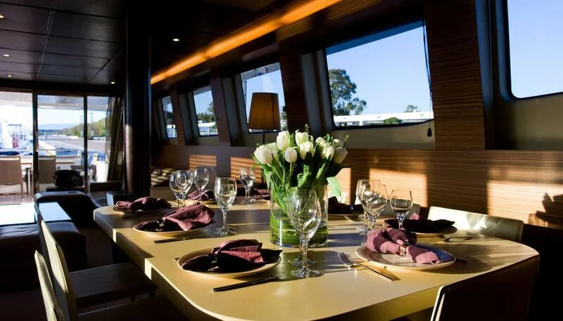 a table with food and flowers aboard GIOE I Yacht for Sale