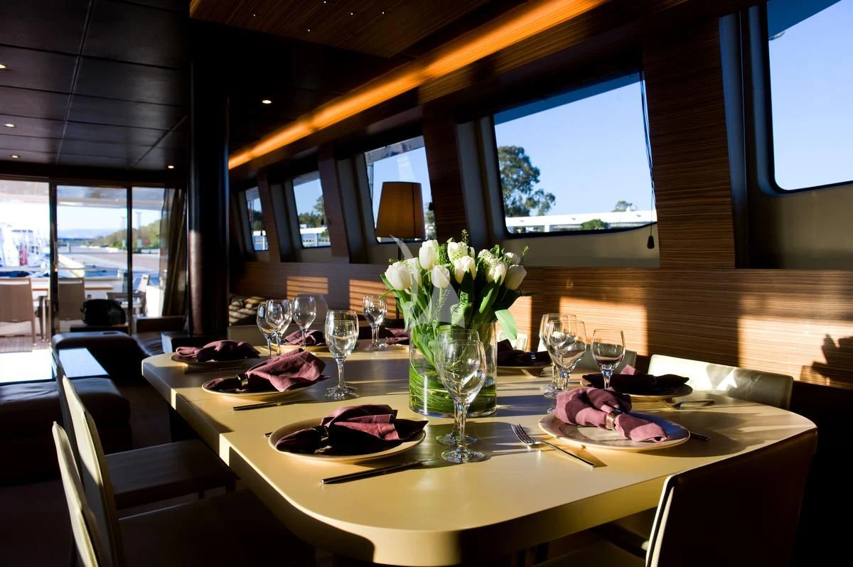 a table with food and flowers aboard GIOE I Yacht for Sale