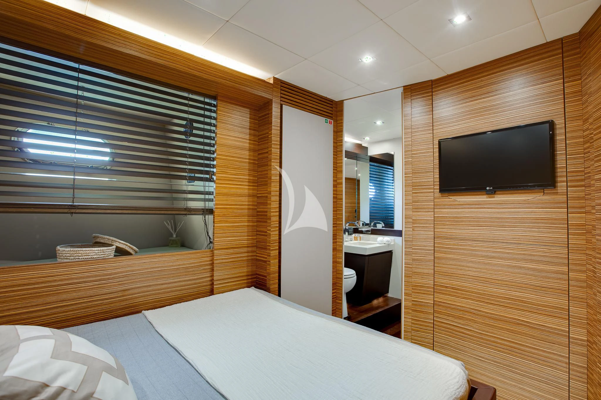 a room with a bed and a television aboard GIOE I Yacht for Sale