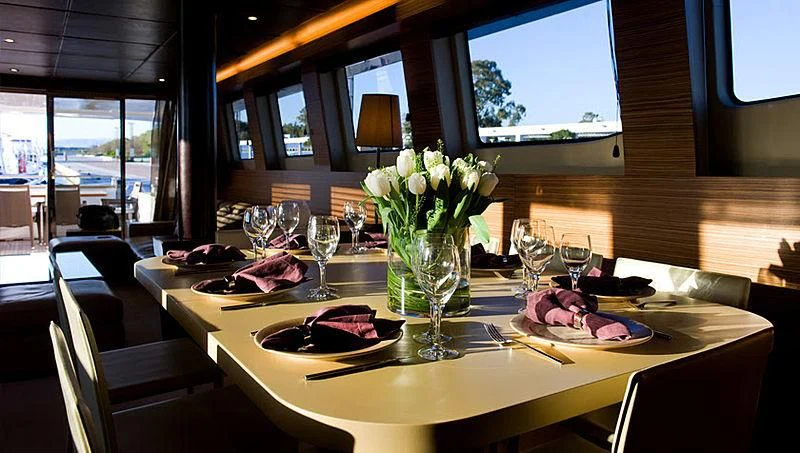a table with food and flowers aboard GIOE I Yacht for Sale