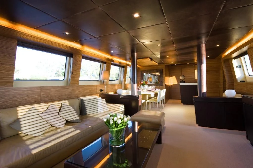 a room with couches and tables aboard GIOE I Yacht for Sale