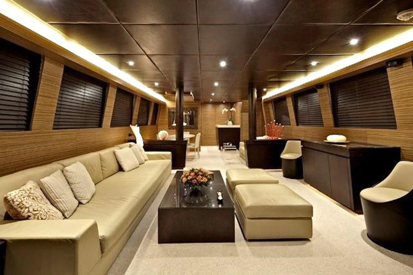 a room with a couch and a coffee table aboard GIOE I Yacht for Sale