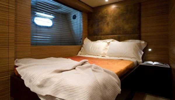 a bed with a white sheet aboard GIOE I Yacht for Sale