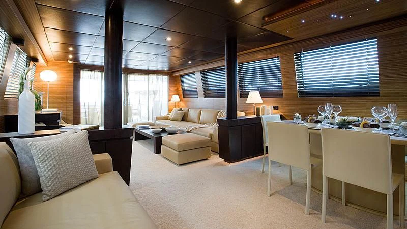 a large living room with a large table and chairs aboard GIOE I Yacht for Sale