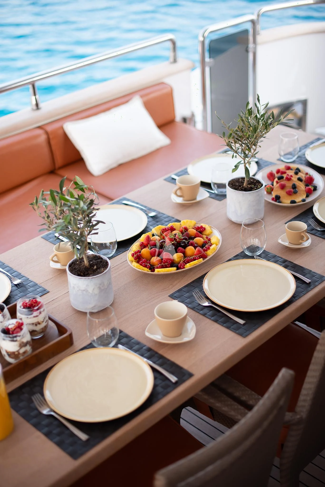 a table with plates and cups on it aboard GIOE I Yacht for Sale