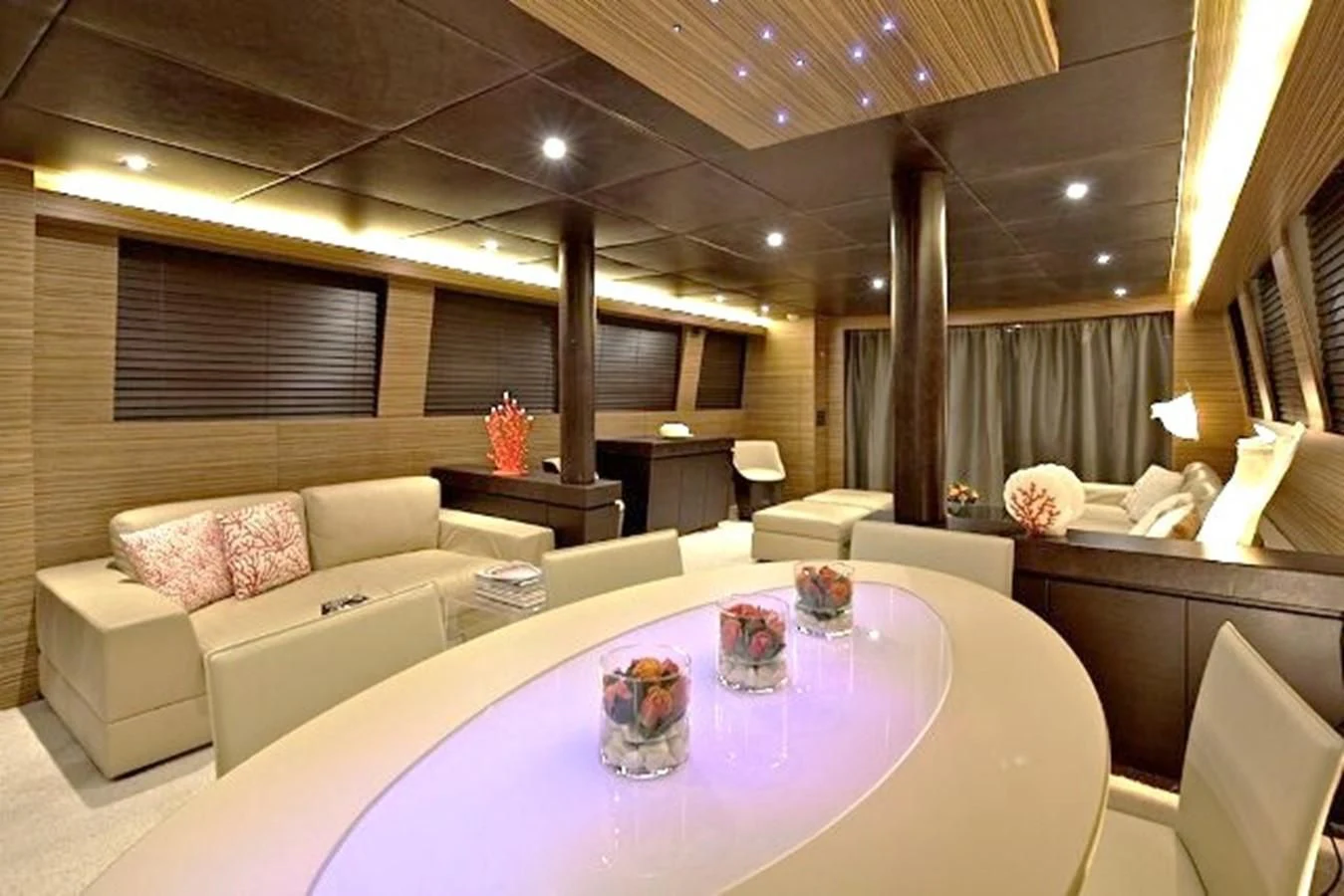 a room with a table and couches aboard GIOE I Yacht for Sale