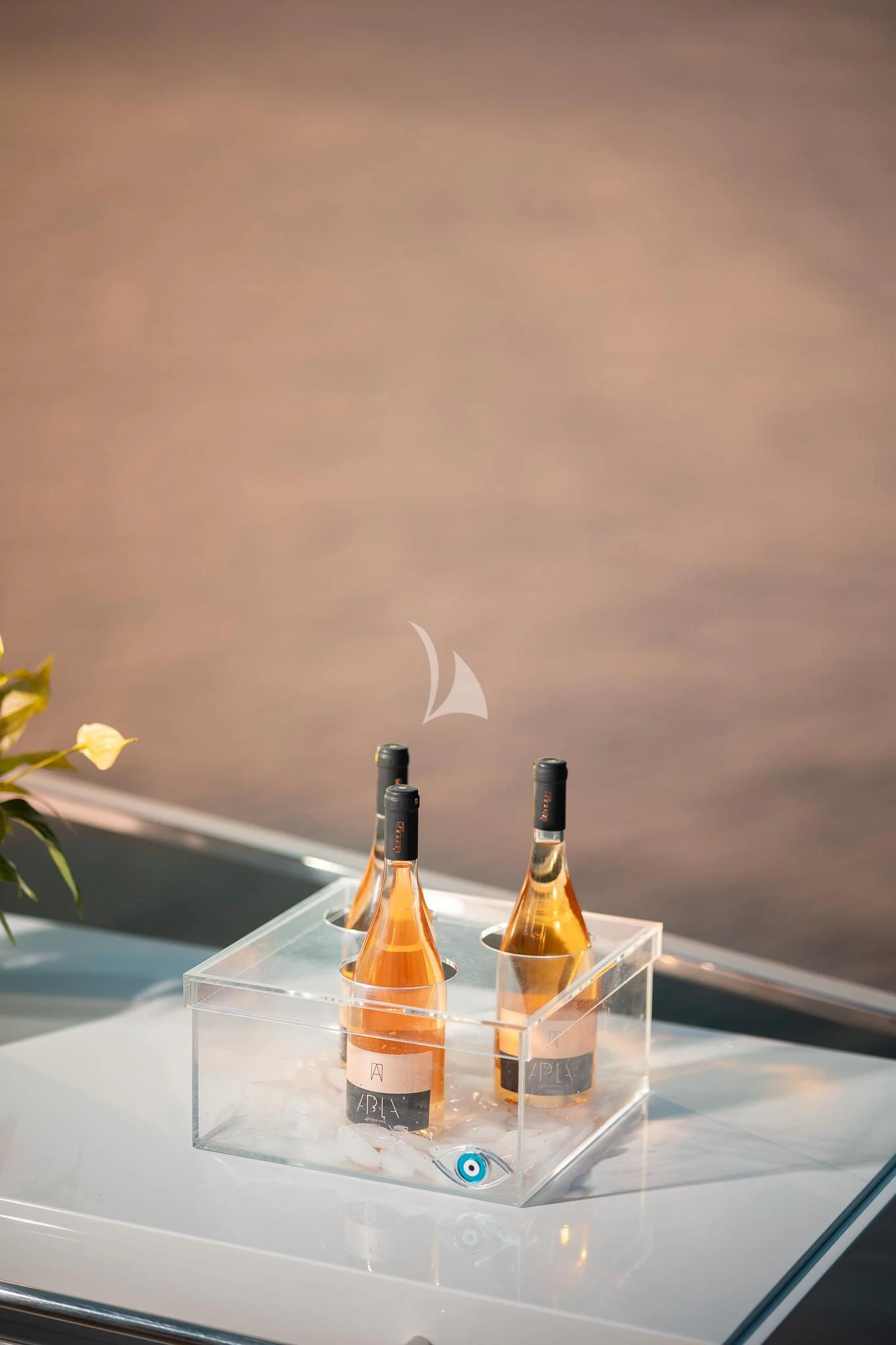 a bottle of liquor and a glass on a table aboard GIOE I Yacht for Sale