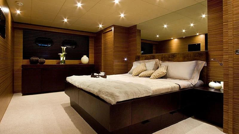 a room with a bed and a desk aboard GIOE I Yacht for Sale