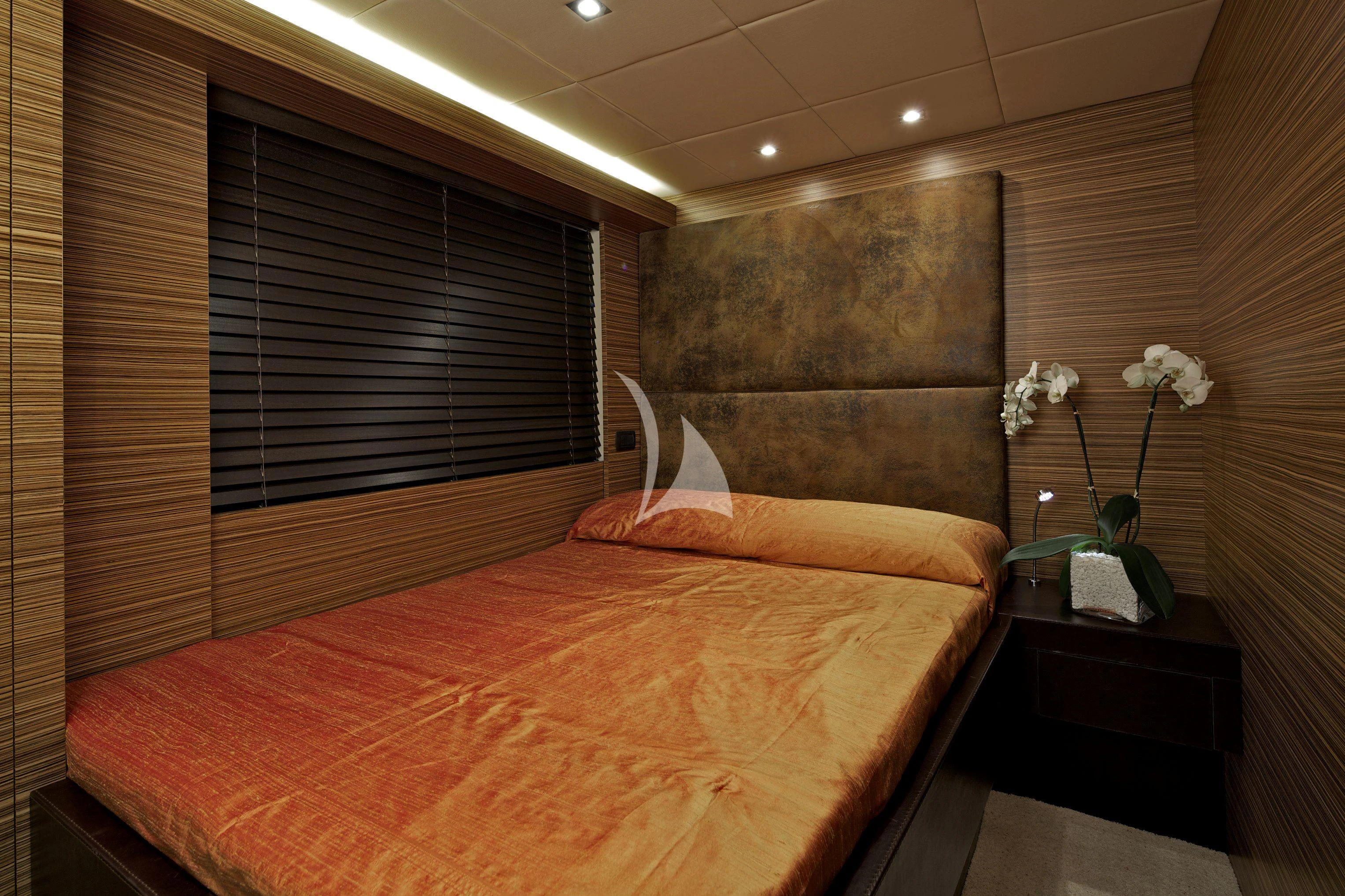 a bed with a flower on the bed aboard GIOE I Yacht for Sale