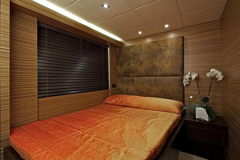 a bedroom with a bed and a wall of windows aboard GIOE I Yacht for Sale