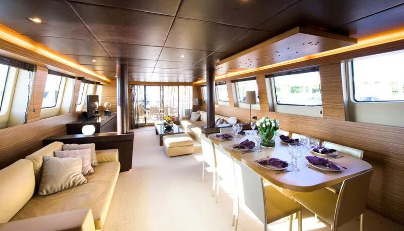 a room with a table and chairs aboard GIOE I Yacht for Sale