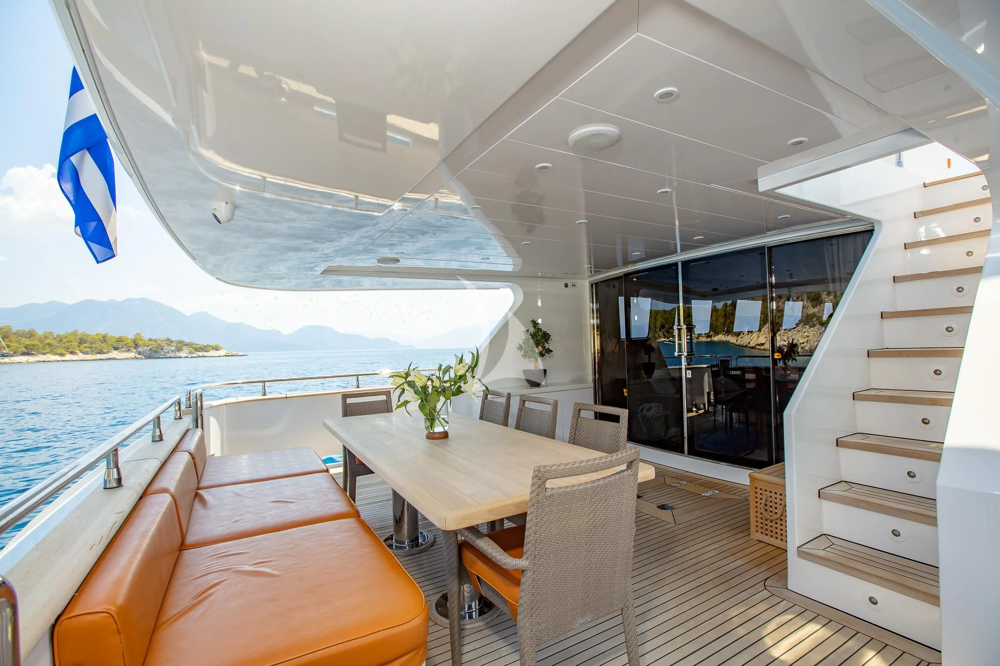 a room with a table and chairs aboard GIOE I Yacht for Sale