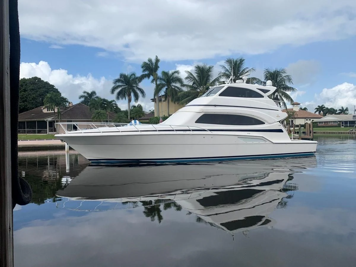 a white boat in a body of water aboard REEL BUSY Yacht for Sale