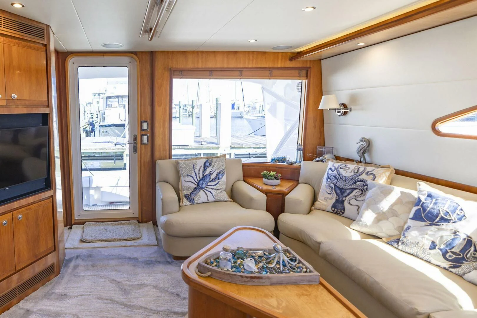a living room with a couch and a television aboard REEL BUSY Yacht for Sale