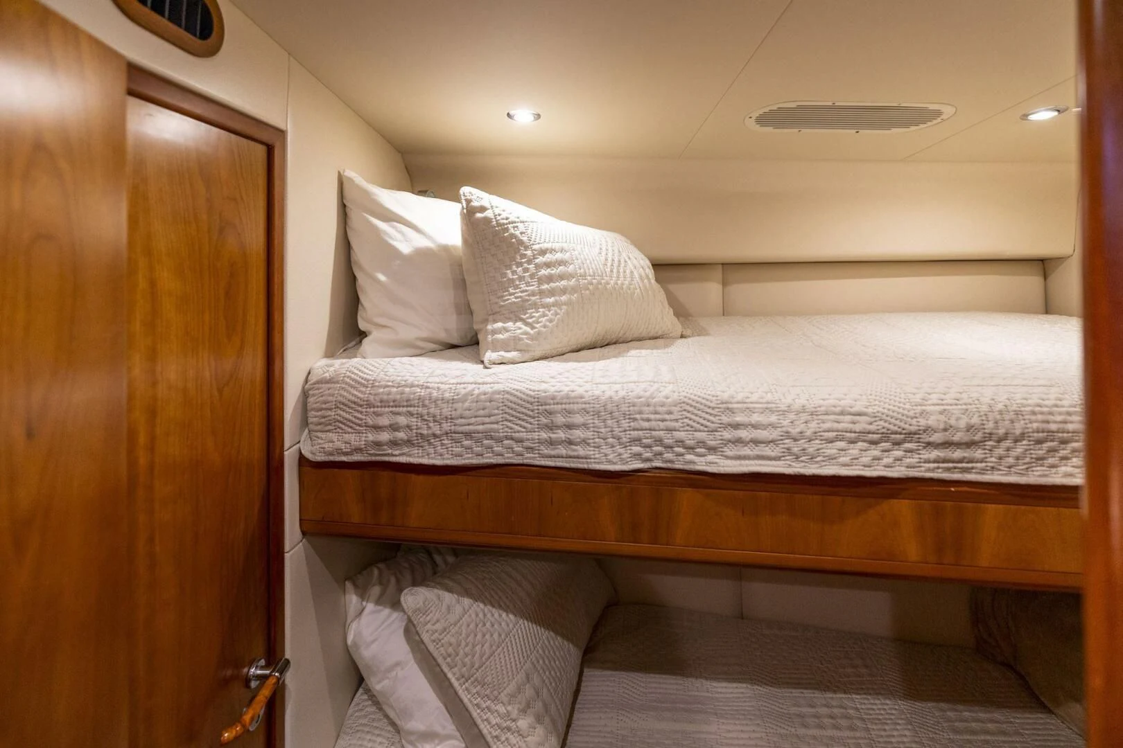 a bed with white sheets aboard REEL BUSY Yacht for Sale