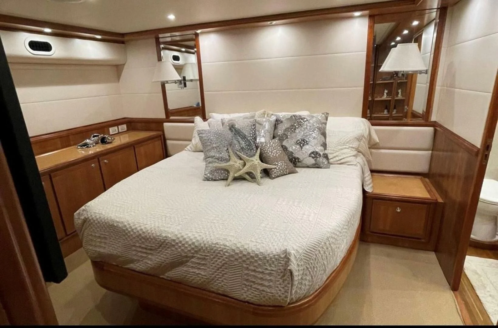 a bed with a white comforter aboard REEL BUSY Yacht for Sale
