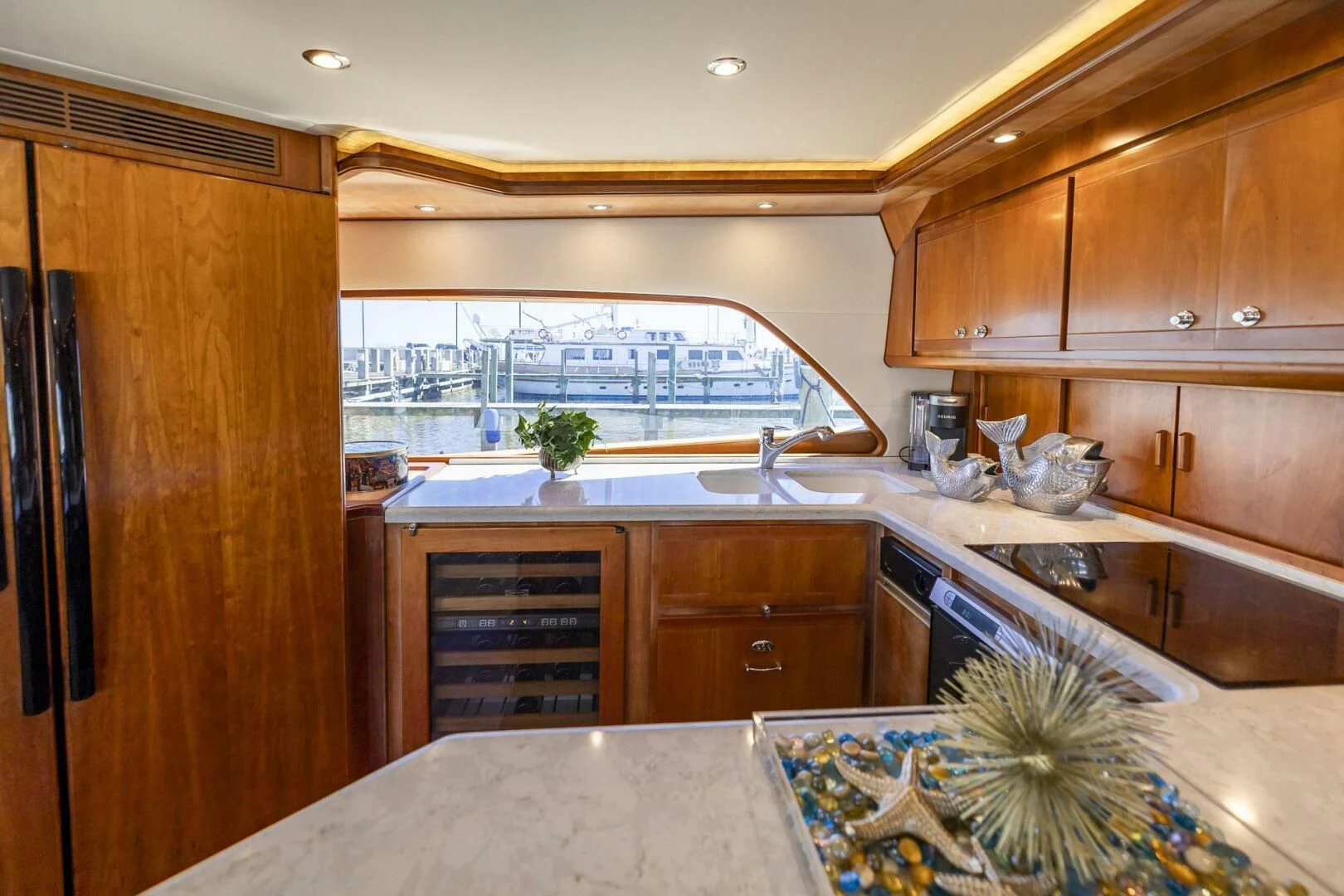 a kitchen with wooden cabinets aboard REEL BUSY Yacht for Sale