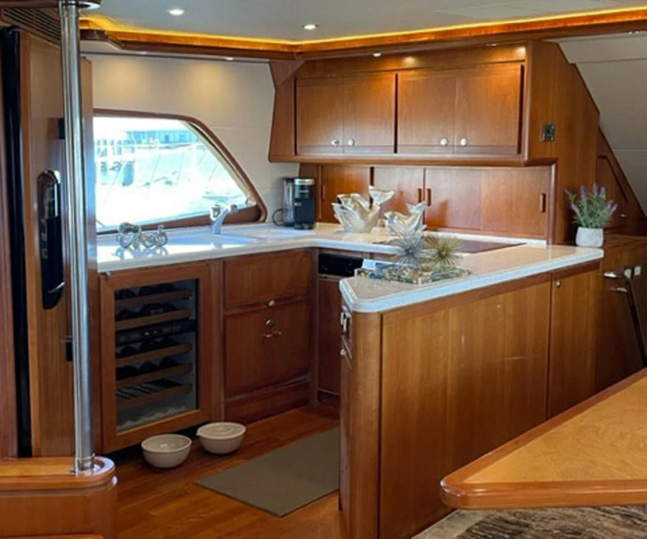 a kitchen with wooden cabinets aboard REEL BUSY Yacht for Sale