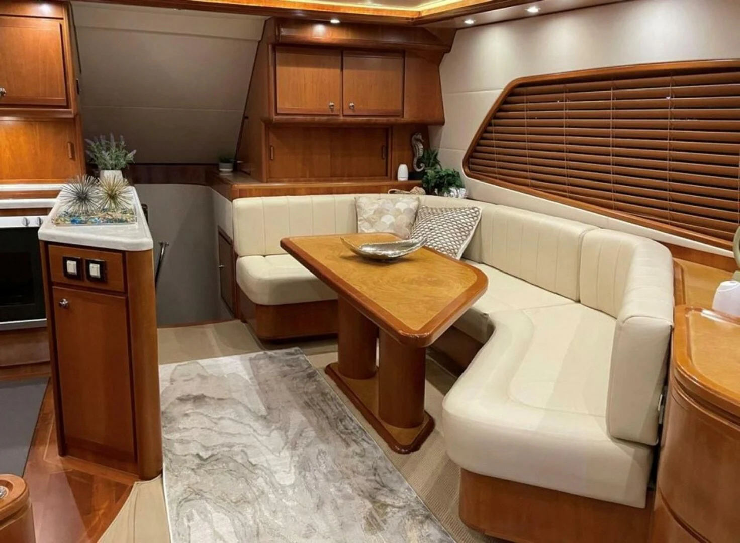 a living room with a table and chairs aboard REEL BUSY Yacht for Sale