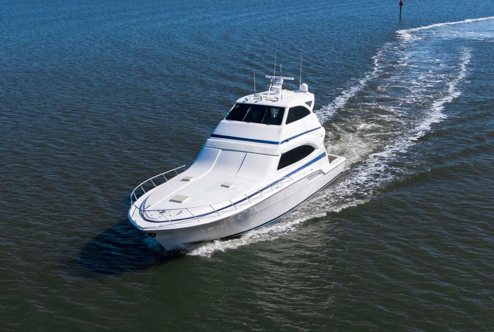 a white boat on the water aboard REEL BUSY Yacht for Sale