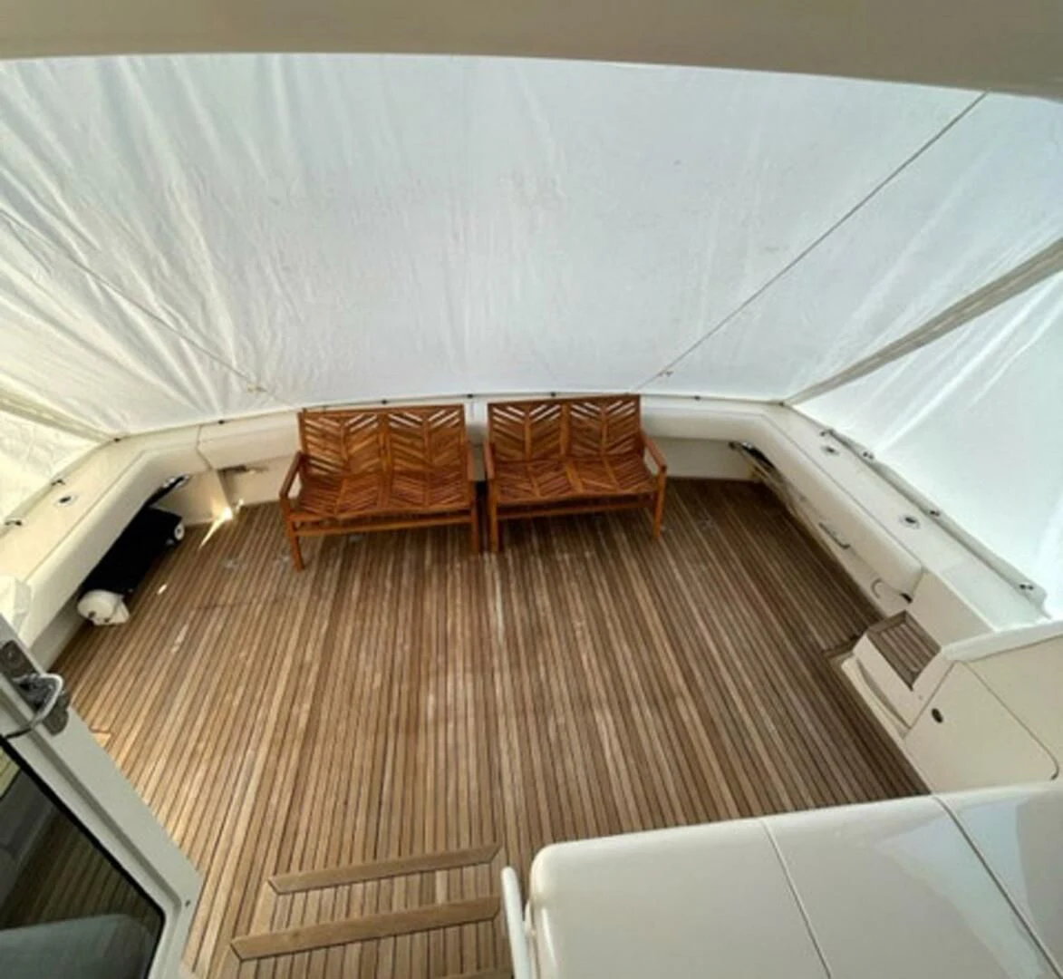 a room with a bed and a chair aboard REEL BUSY Yacht for Sale