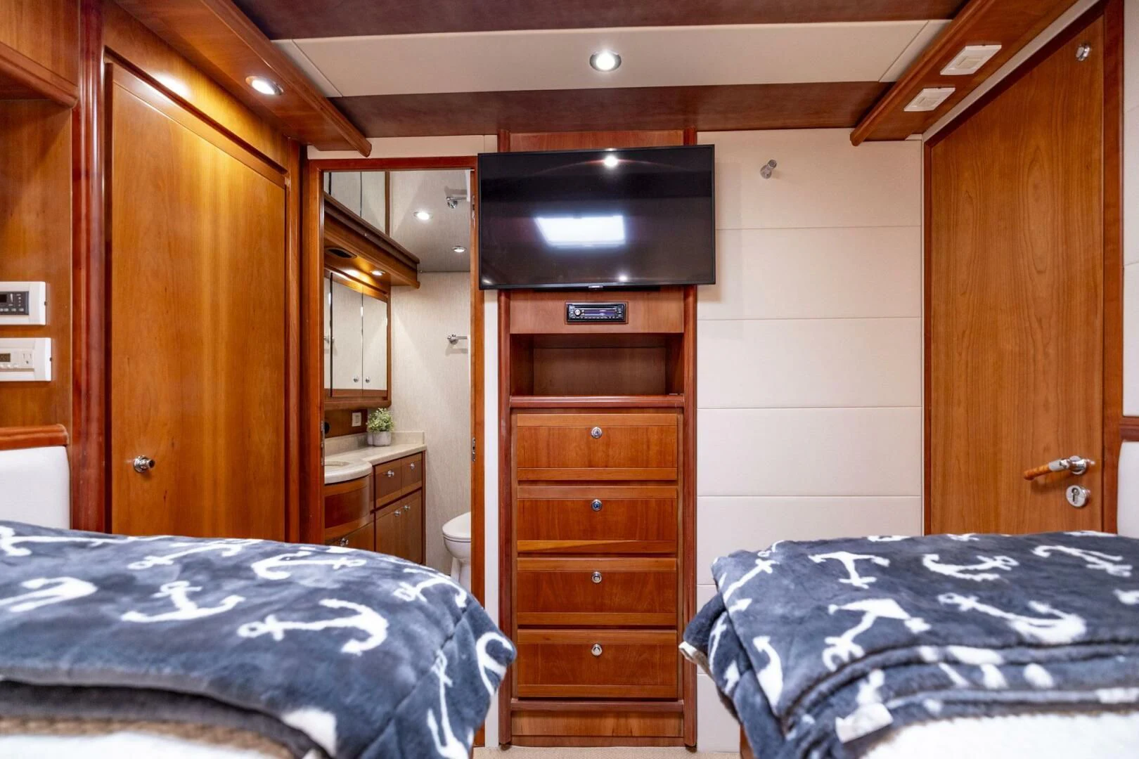 a bedroom with a bed and a dresser aboard REEL BUSY Yacht for Sale