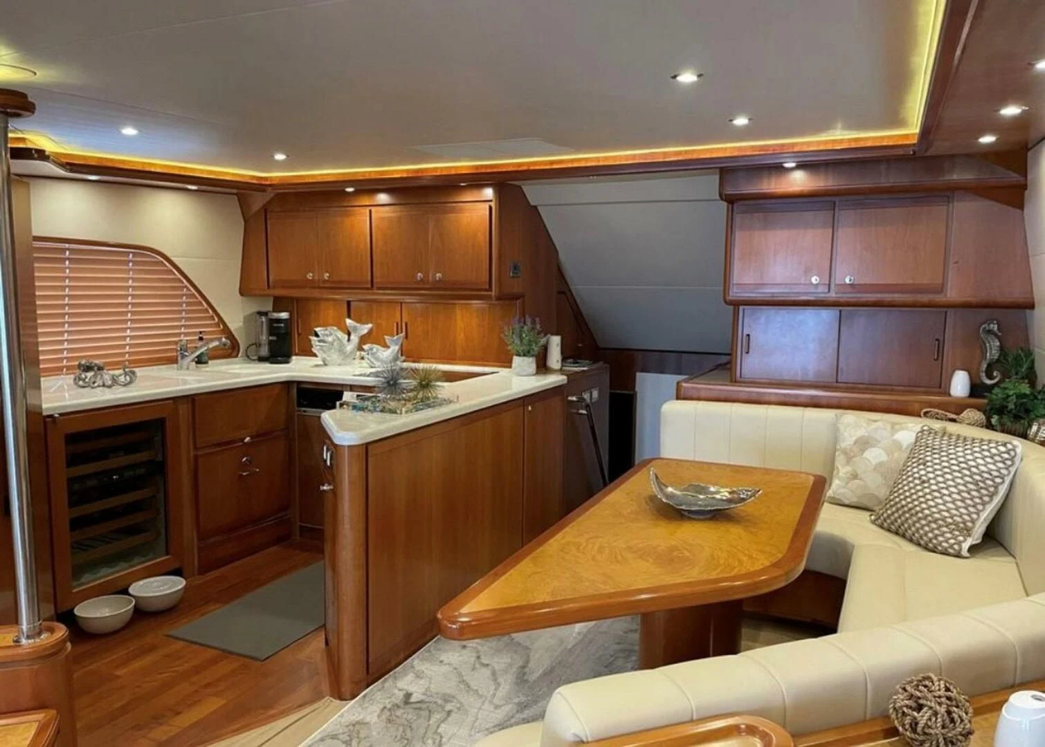 a kitchen with a table and couch aboard REEL BUSY Yacht for Sale