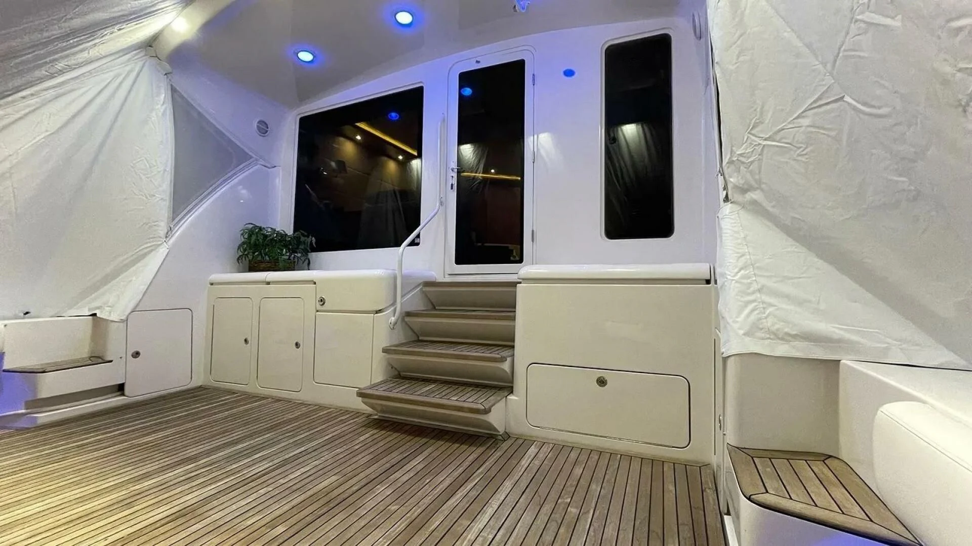 a white room with a staircase and a window aboard REEL BUSY Yacht for Sale