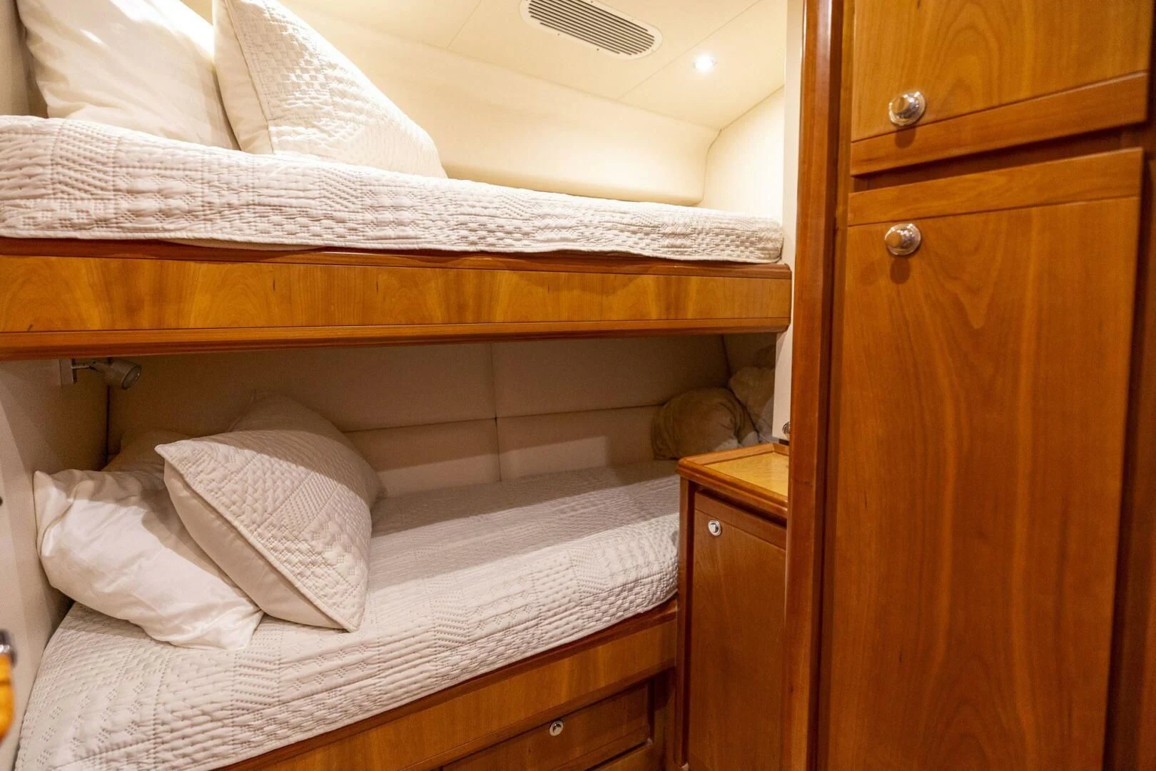a bed with white sheets aboard REEL BUSY Yacht for Sale