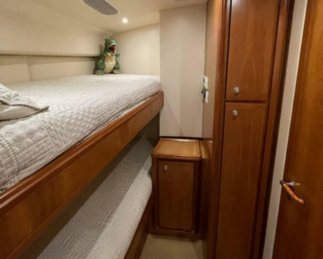 a bedroom with a bed and a stuffed animal aboard REEL BUSY Yacht for Sale