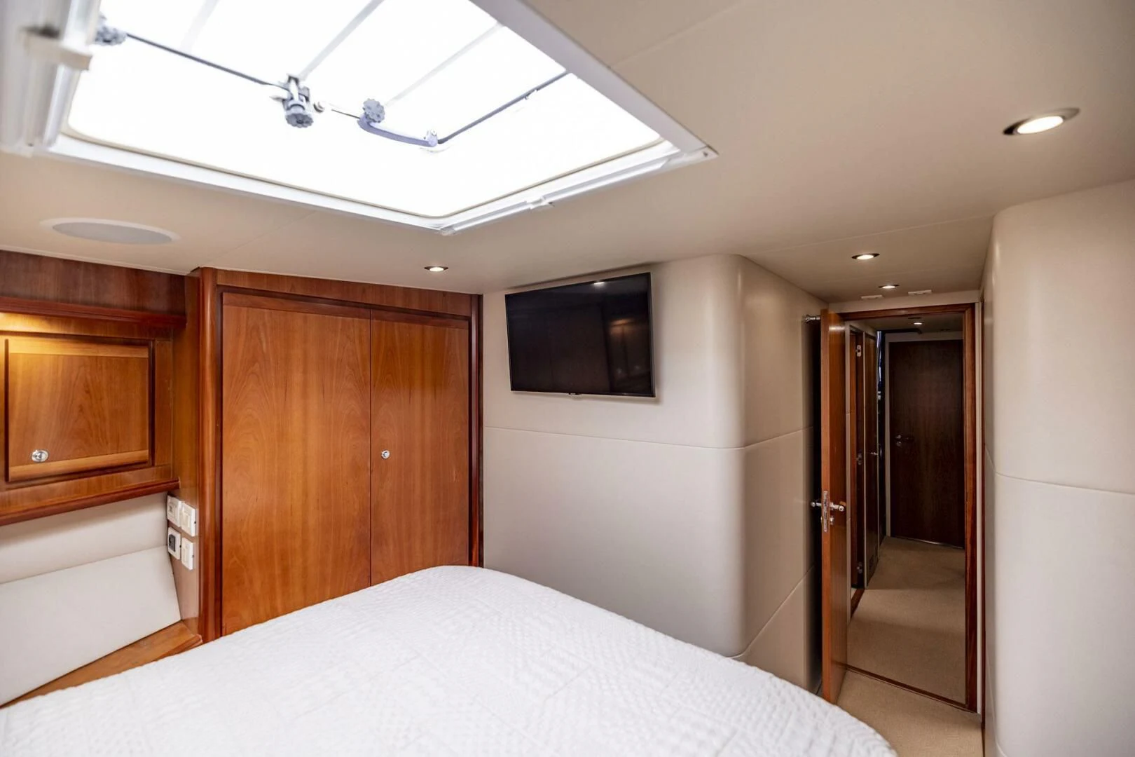 a bedroom with a bed and a television on the ceiling aboard REEL BUSY Yacht for Sale