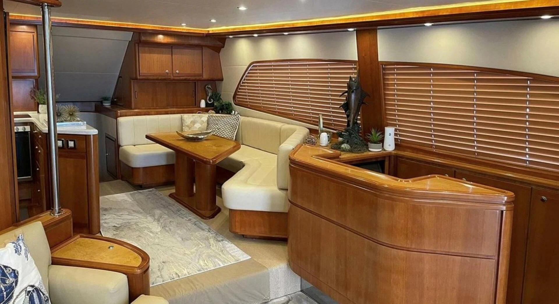 a living room with a couch and a table aboard REEL BUSY Yacht for Sale