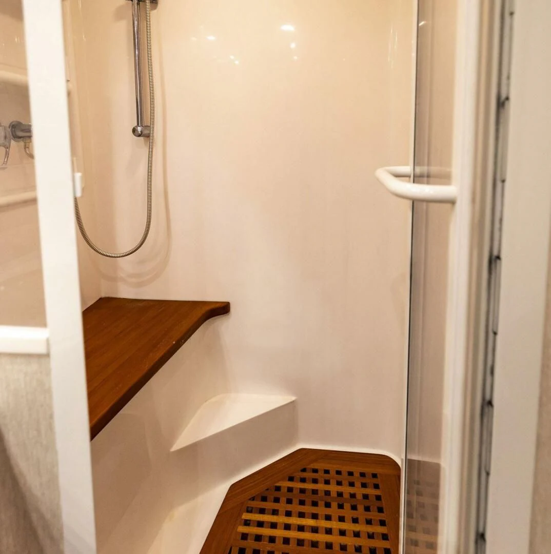 a white door with a metal handle aboard REEL BUSY Yacht for Sale