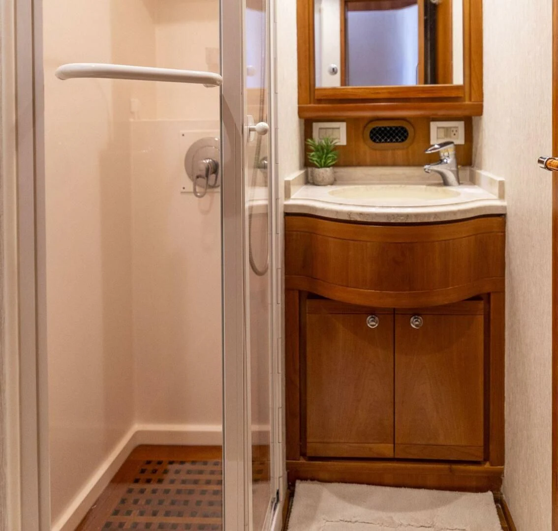 a bathroom with a sink and a shower aboard REEL BUSY Yacht for Sale