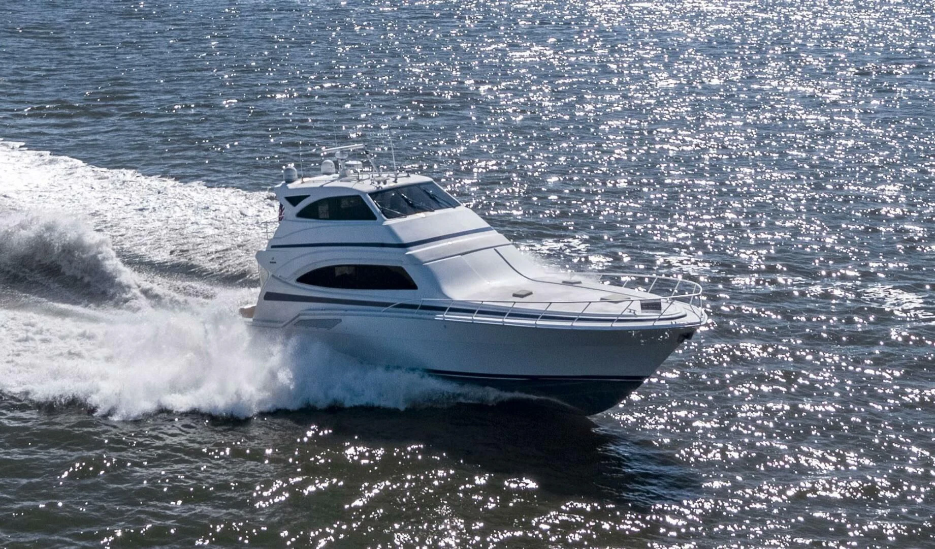 a white yacht on the water aboard REEL BUSY Yacht for Sale