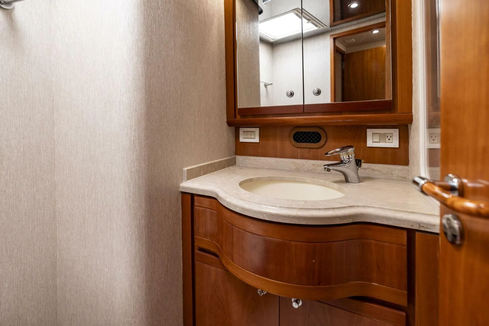 a bathroom with a sink and a mirror aboard REEL BUSY Yacht for Sale