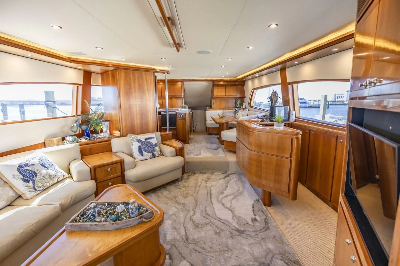 a living room with wood furniture aboard REEL BUSY Yacht for Sale