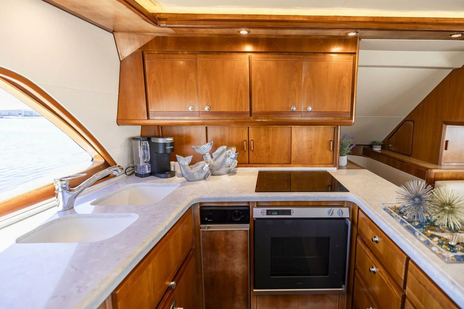 a kitchen with wooden cabinets aboard REEL BUSY Yacht for Sale