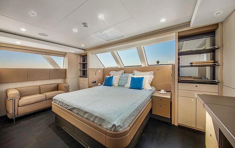 a bedroom with a bed and a couch aboard JANGADA Yacht for Sale