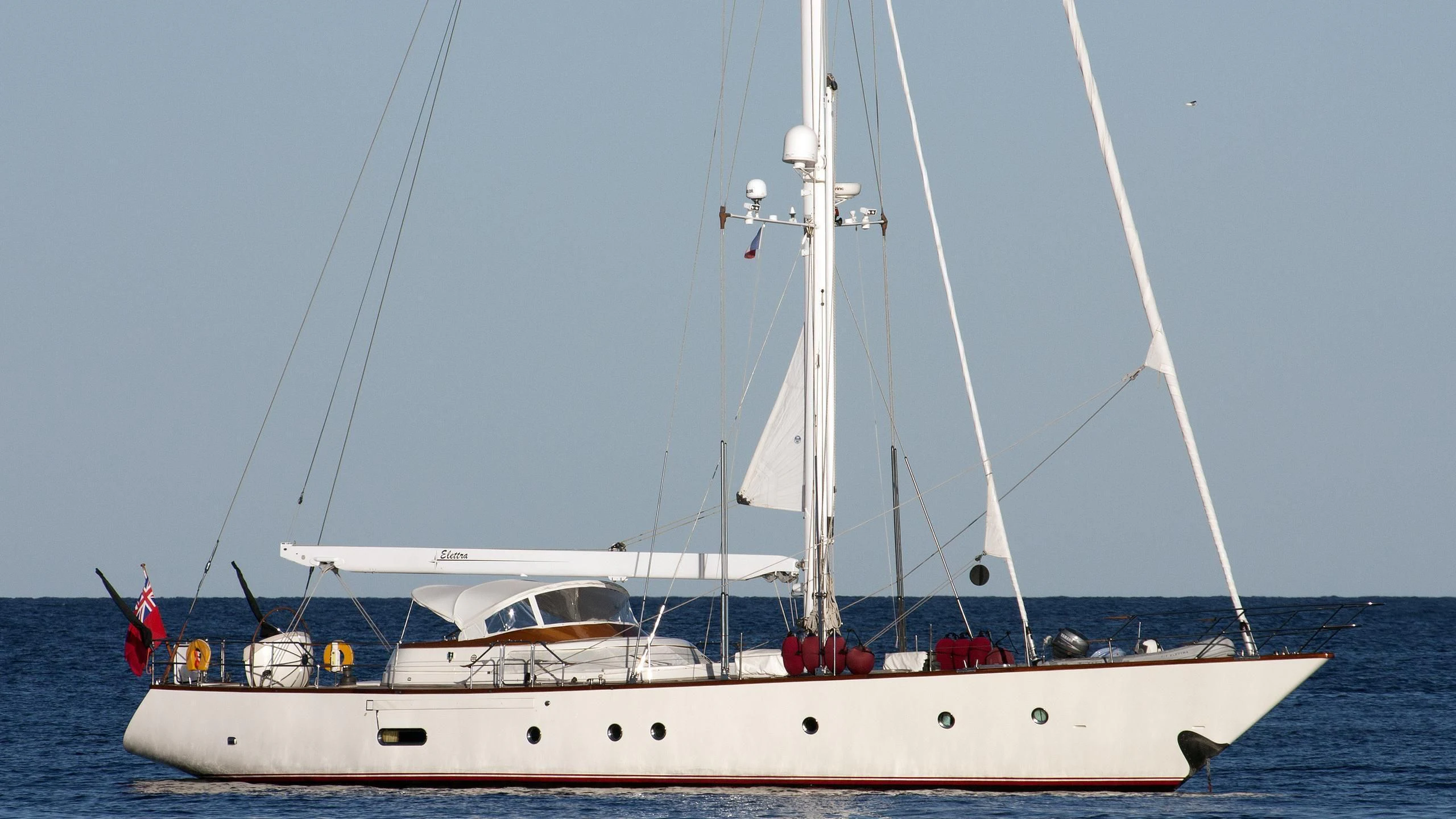 a white boat with a white sail aboard ELETTRA Yacht for Sale