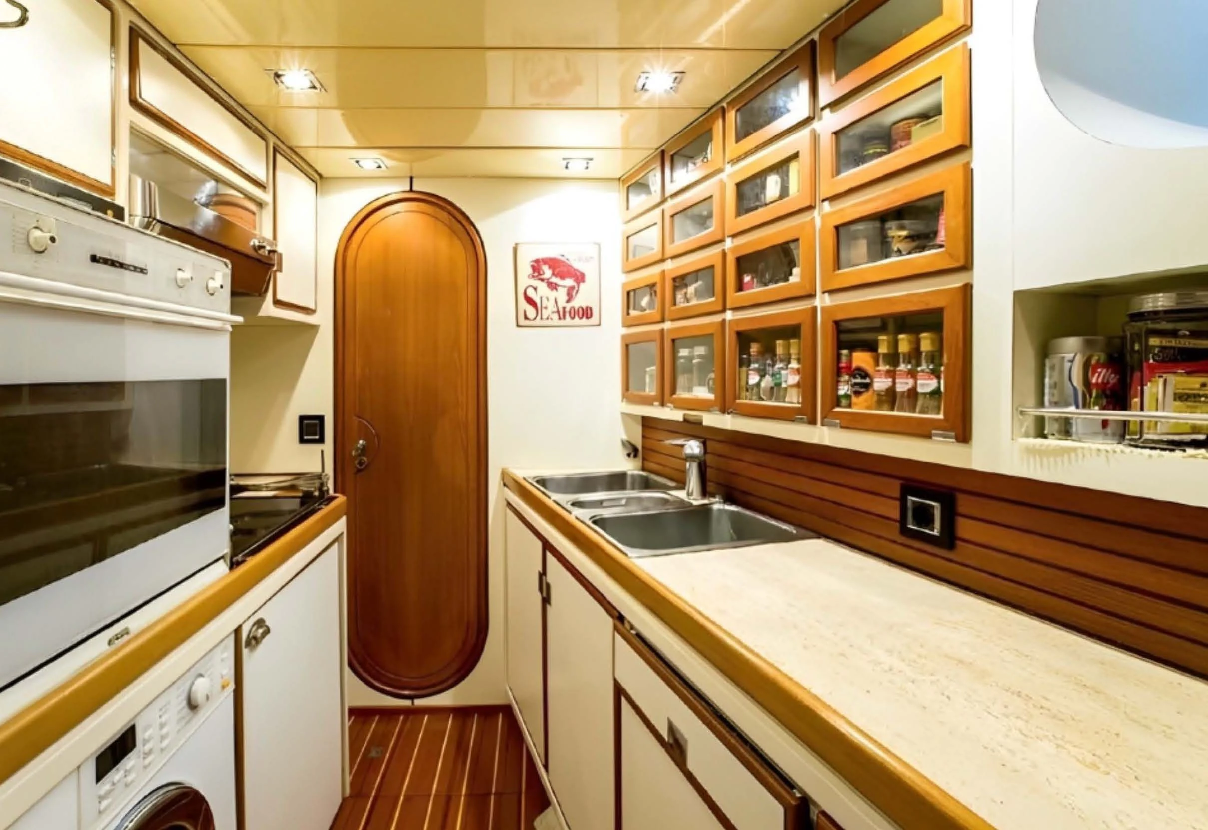 a kitchen with white cabinets aboard ELETTRA Yacht for Sale