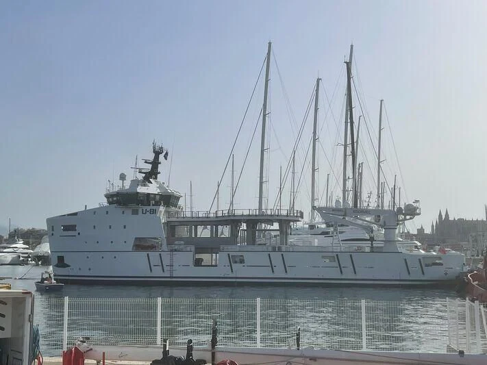 a large ship in a harbor aboard WINGMAN Yacht for Sale