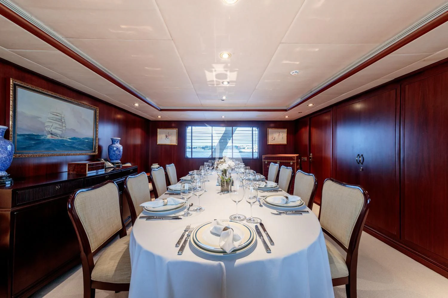a dining room with a table set for a dinner aboard ARIONAS Yacht for Sale
