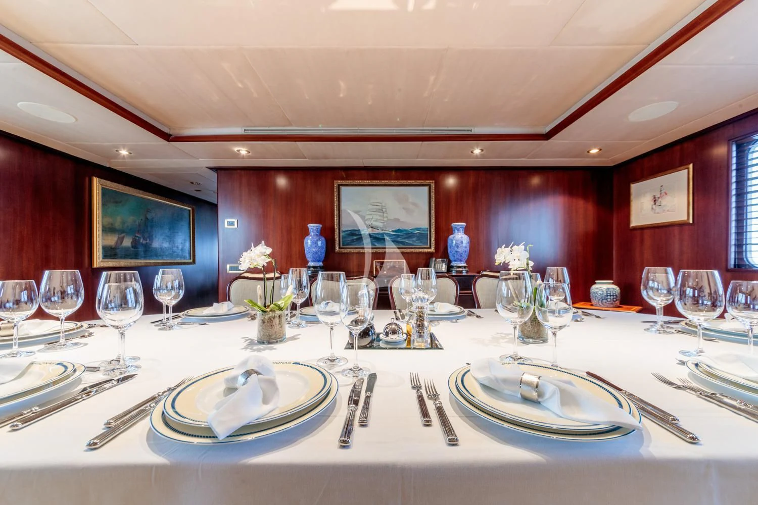 a table with plates and glasses aboard ARIONAS Yacht for Sale
