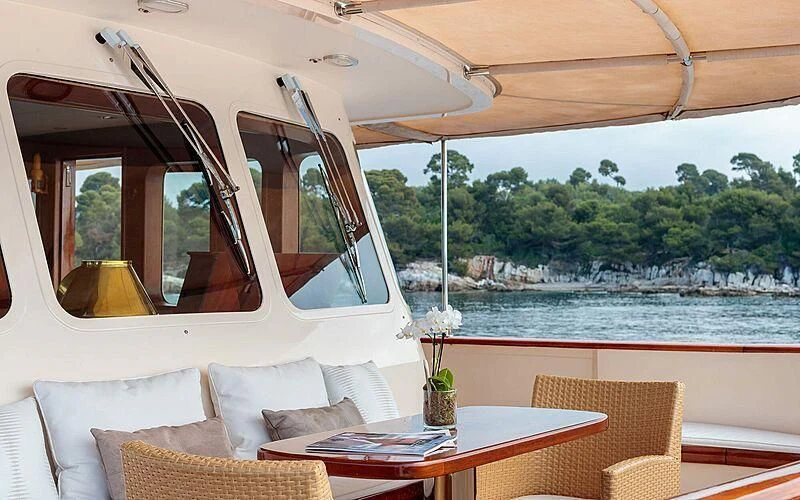 a boat with a table and chairs aboard ARIONAS Yacht for Sale