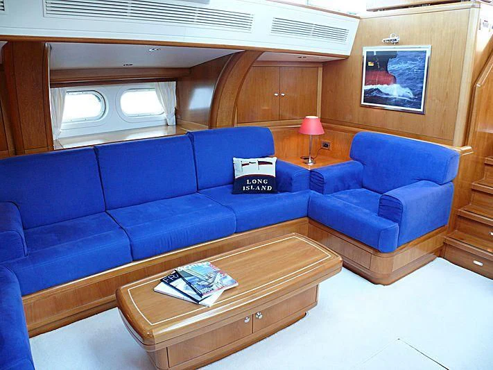 a blue couch in a room aboard NAKUPENDA Yacht for Sale