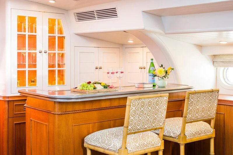 a kitchen with a table and chairs aboard NAKUPENDA Yacht for Sale